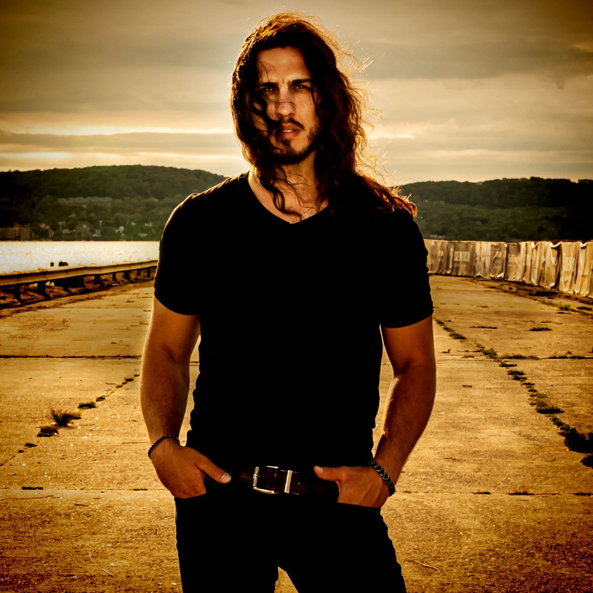 Alex Cano standing at sunset